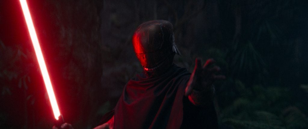 The Stranger wearing cortosis helmet and red lightsaber